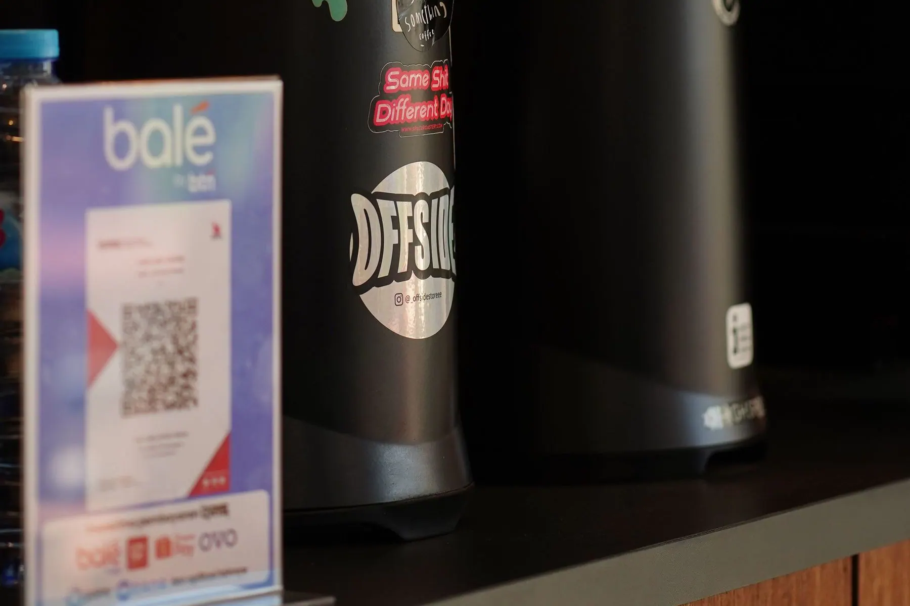 QR payment sign positioned beside a cafe checkout