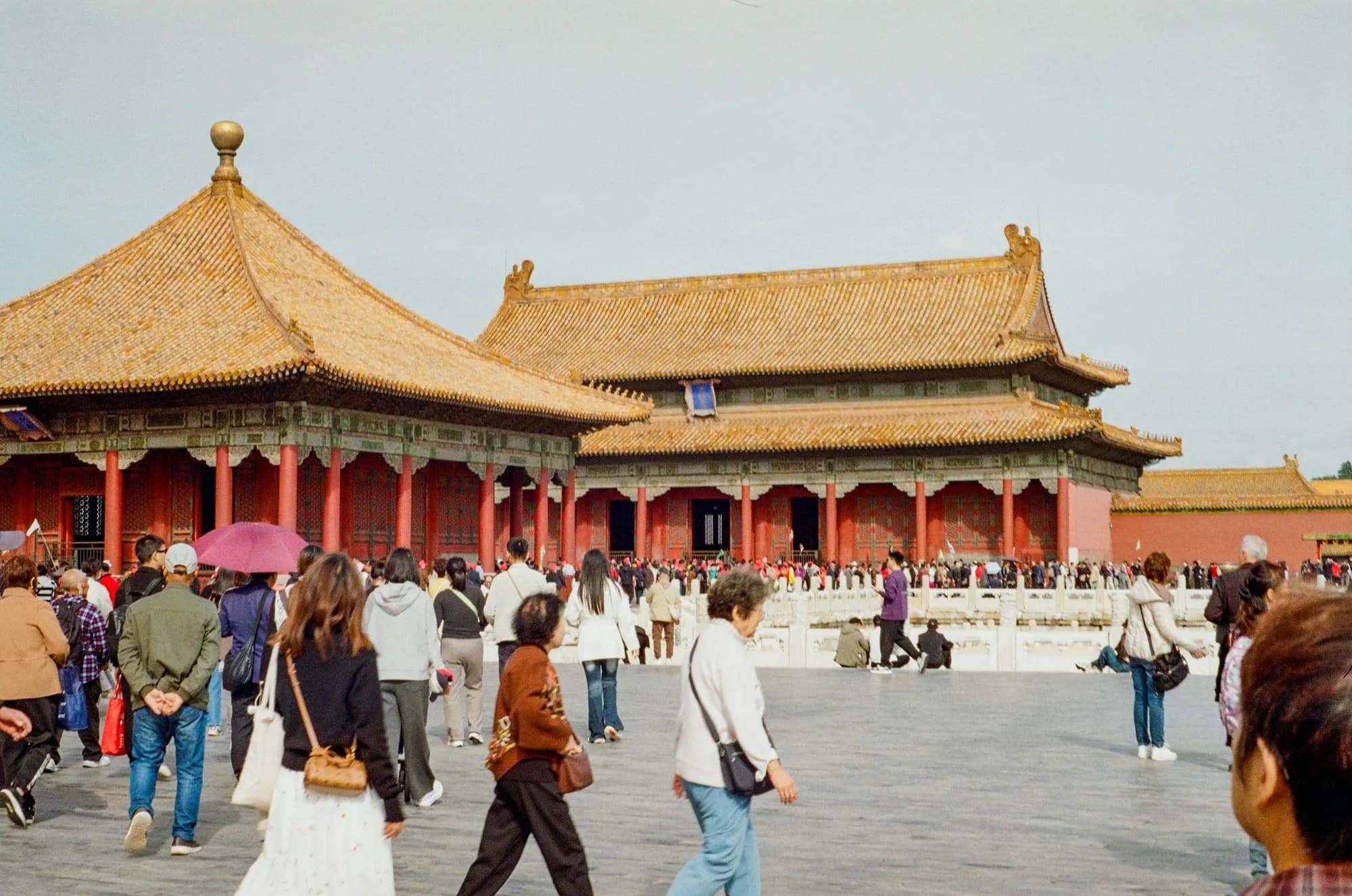 Visitors walking through a courtyard in Beijing's Forbidden City