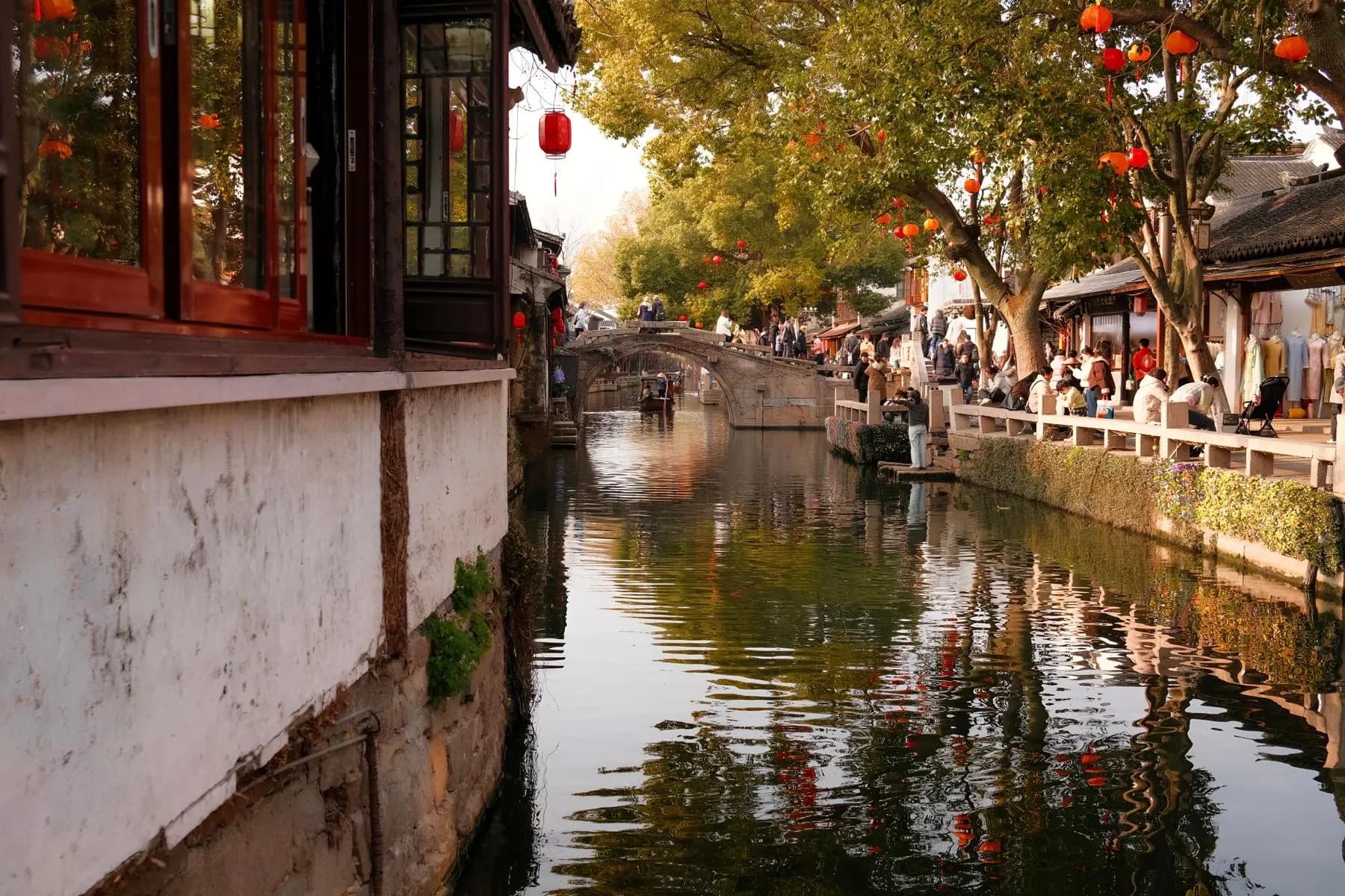 Traditional houses and red lanterns beside a canal in Suzhou
