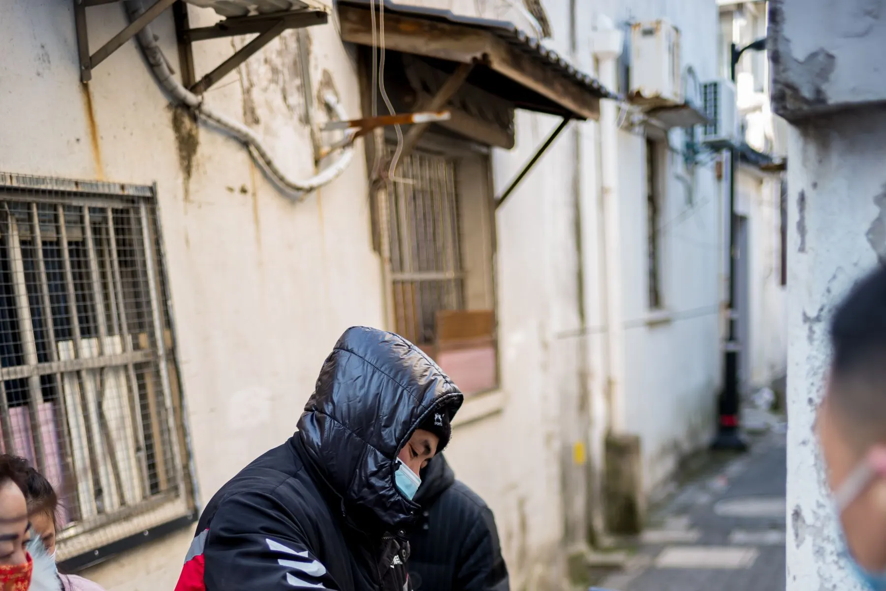 Street food vendor serving customers in a Suzhou alley