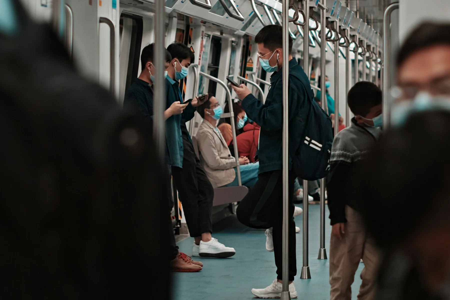 Passengers using smartphones inside a Shenzhen Metro train