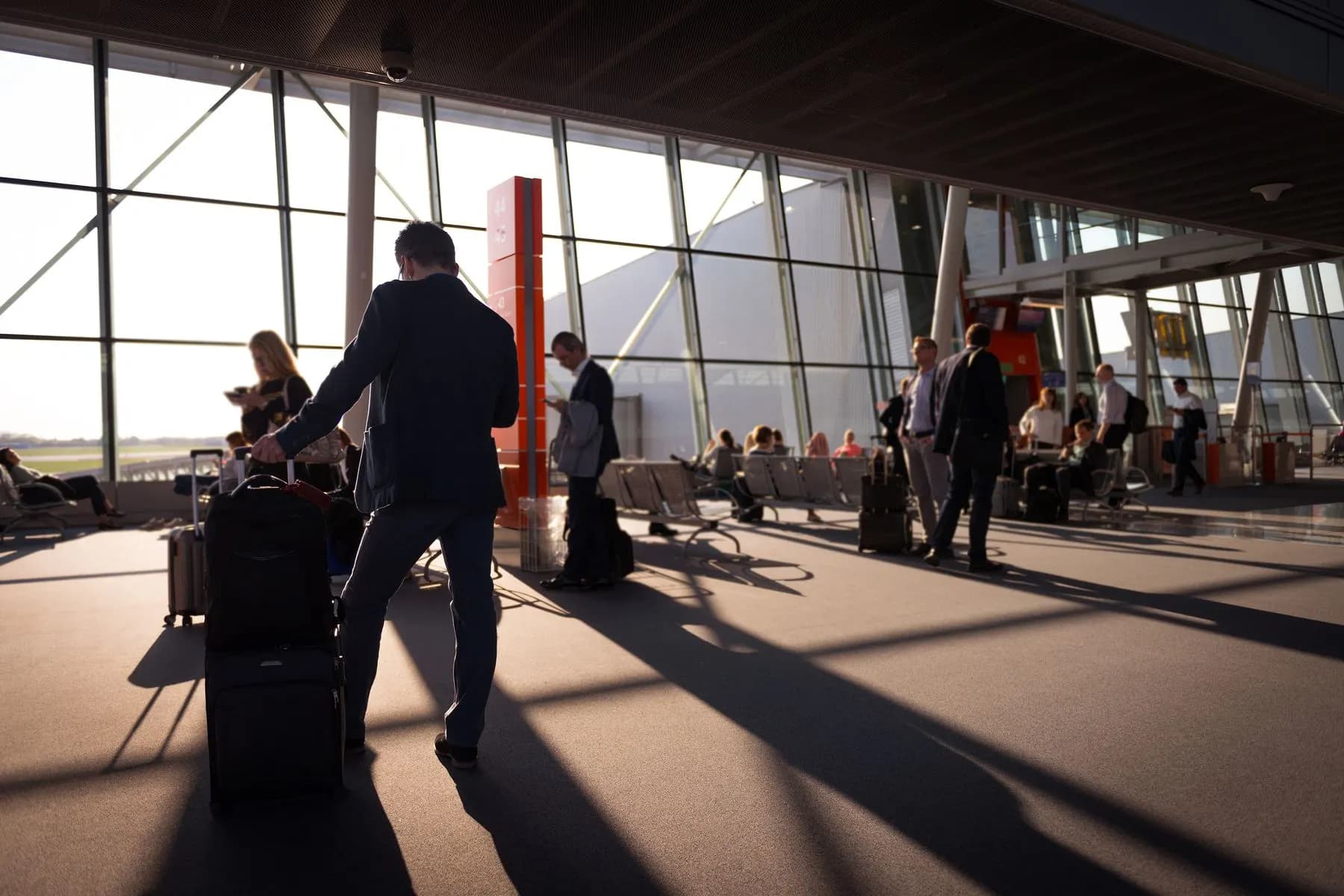International passengers with luggage inside an airport terminal