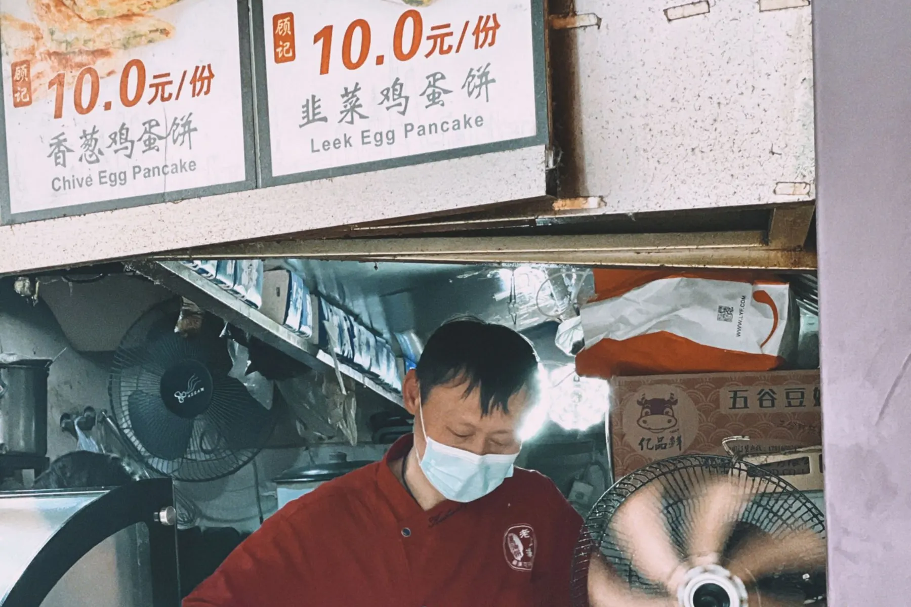 Cook preparing food at a street stall in Shanghai
