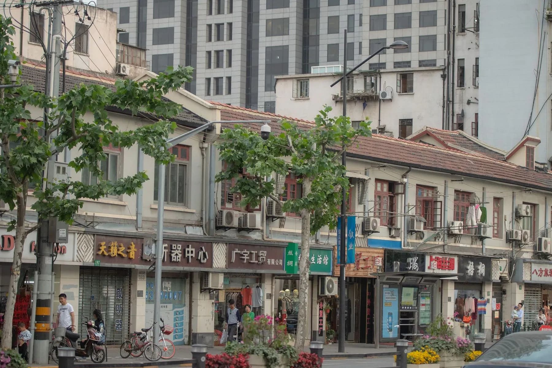 Historic Shanghai storefronts beneath the modern city skyline