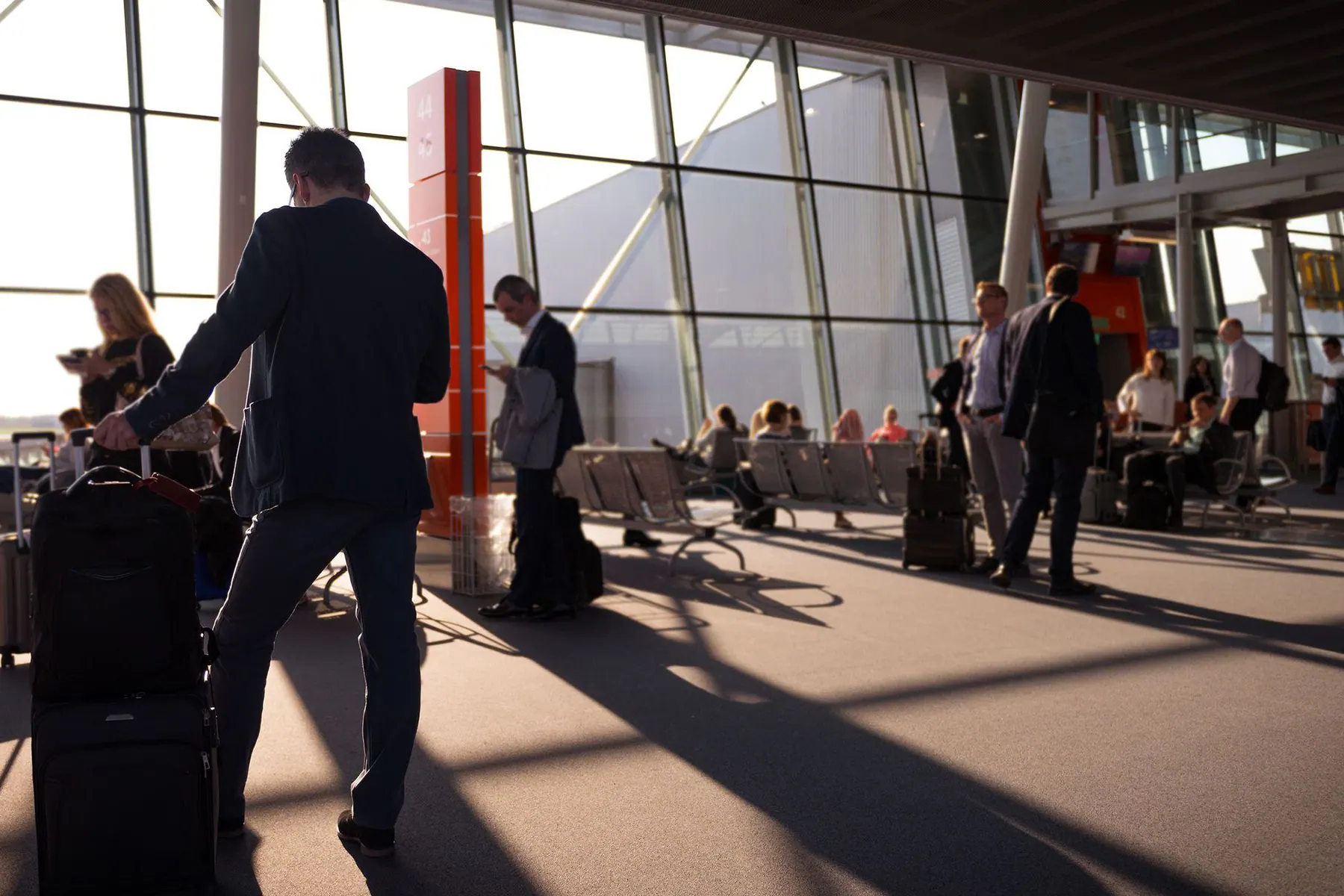 International traveler pulling luggage through an airport terminal
