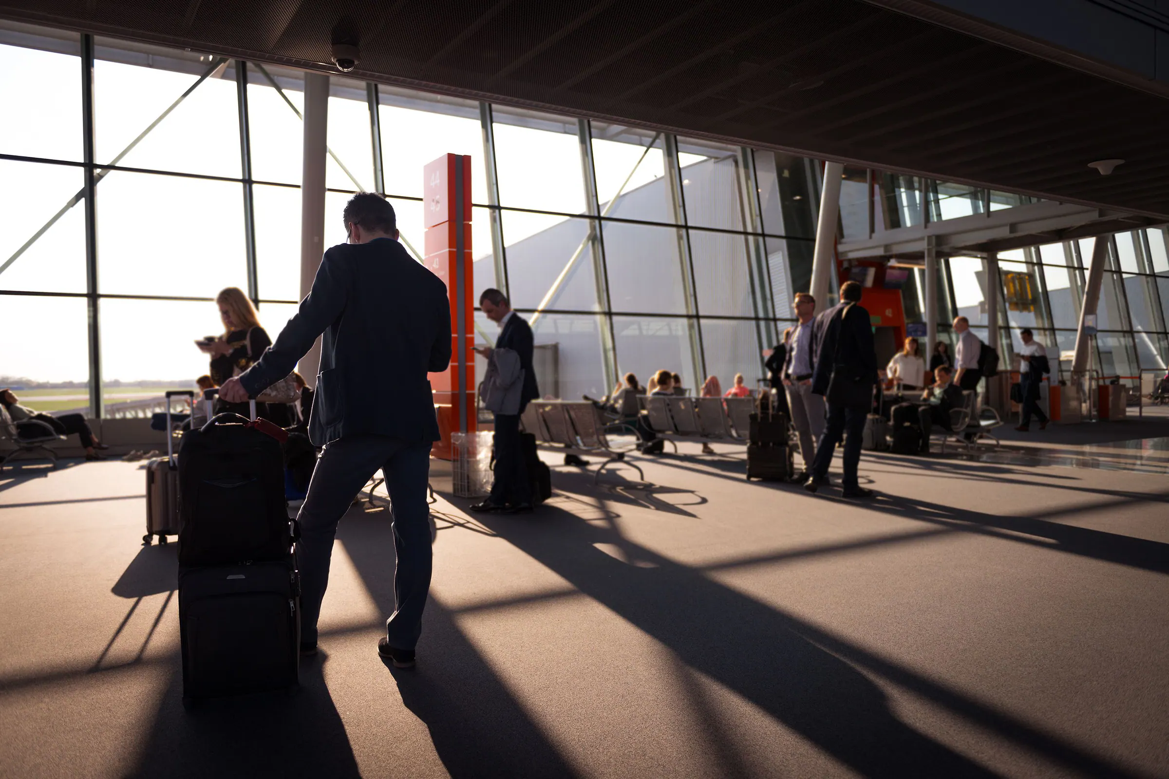 International passengers with luggage moving through an airport terminal