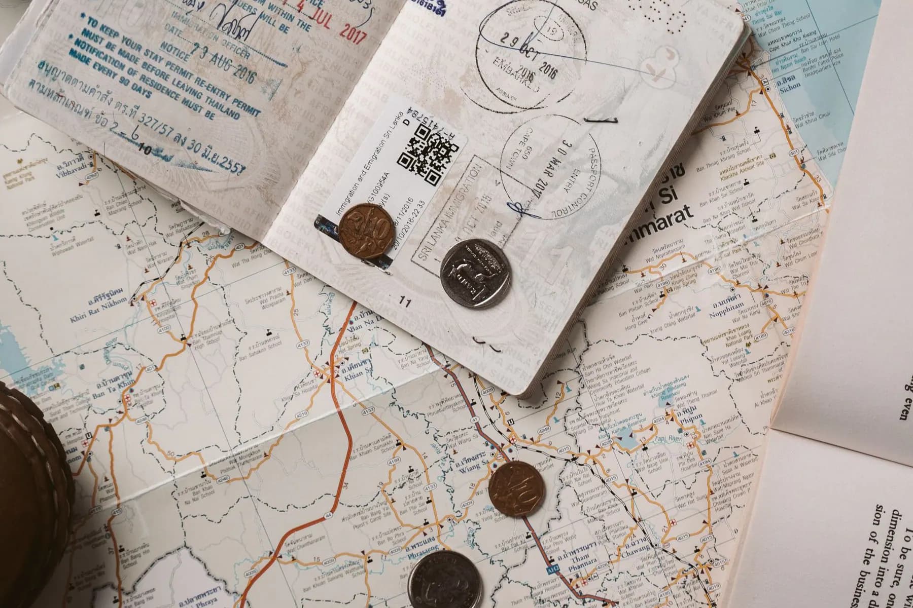 Passport and practical travel items arranged on a map
