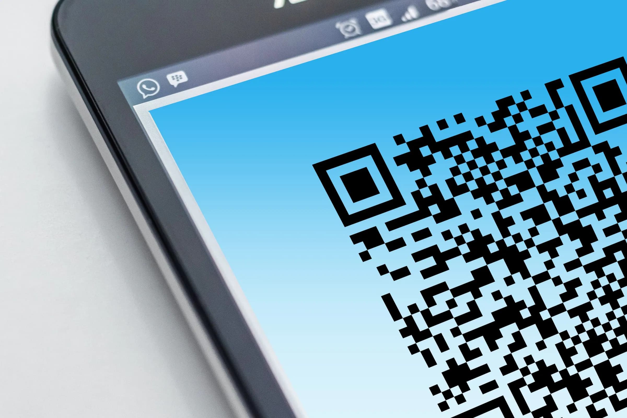 Smartphone showing a customer QR code for a cashier to scan