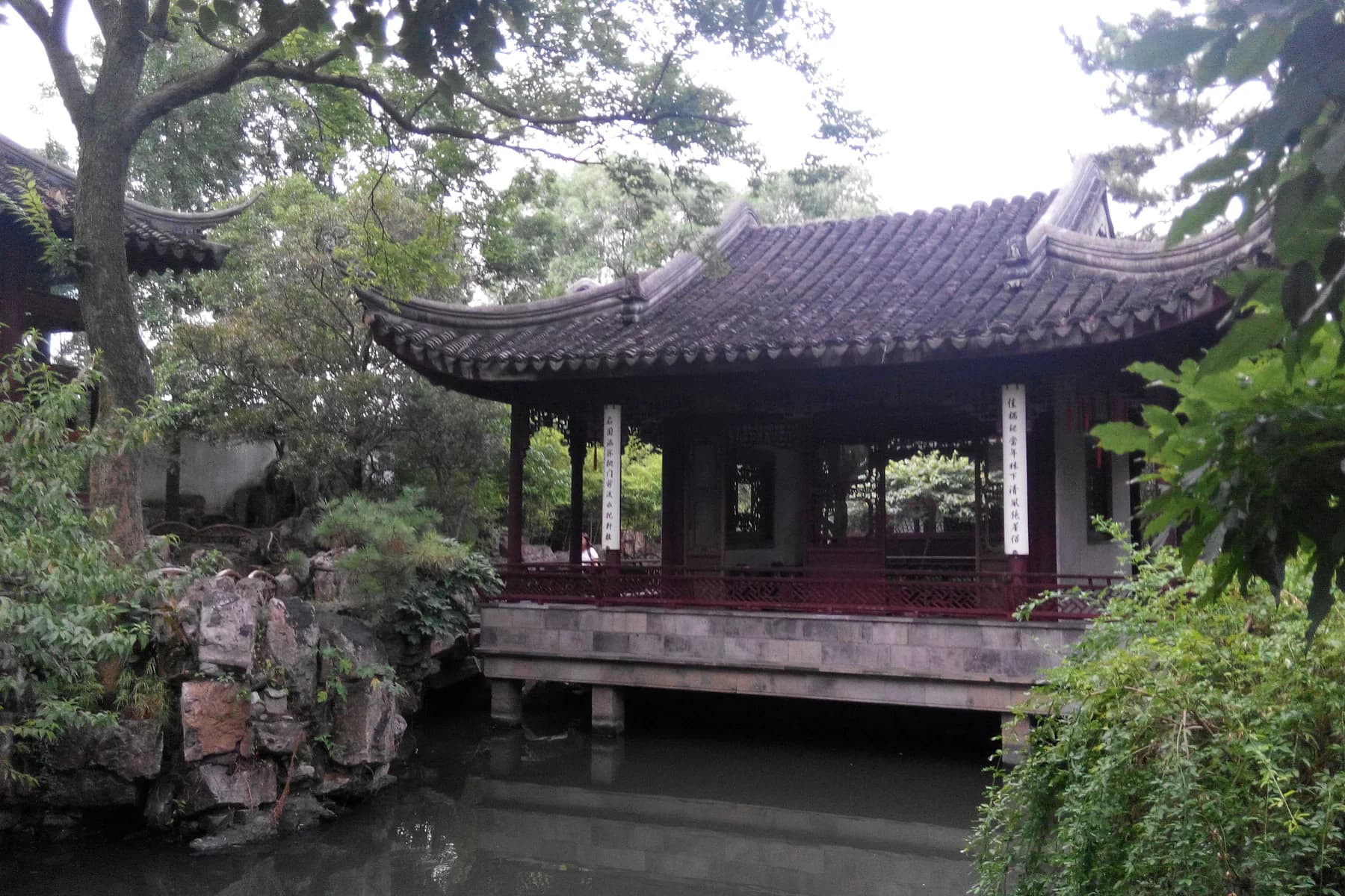 Traditional pavilion and landscaped pond in a classical Suzhou garden
