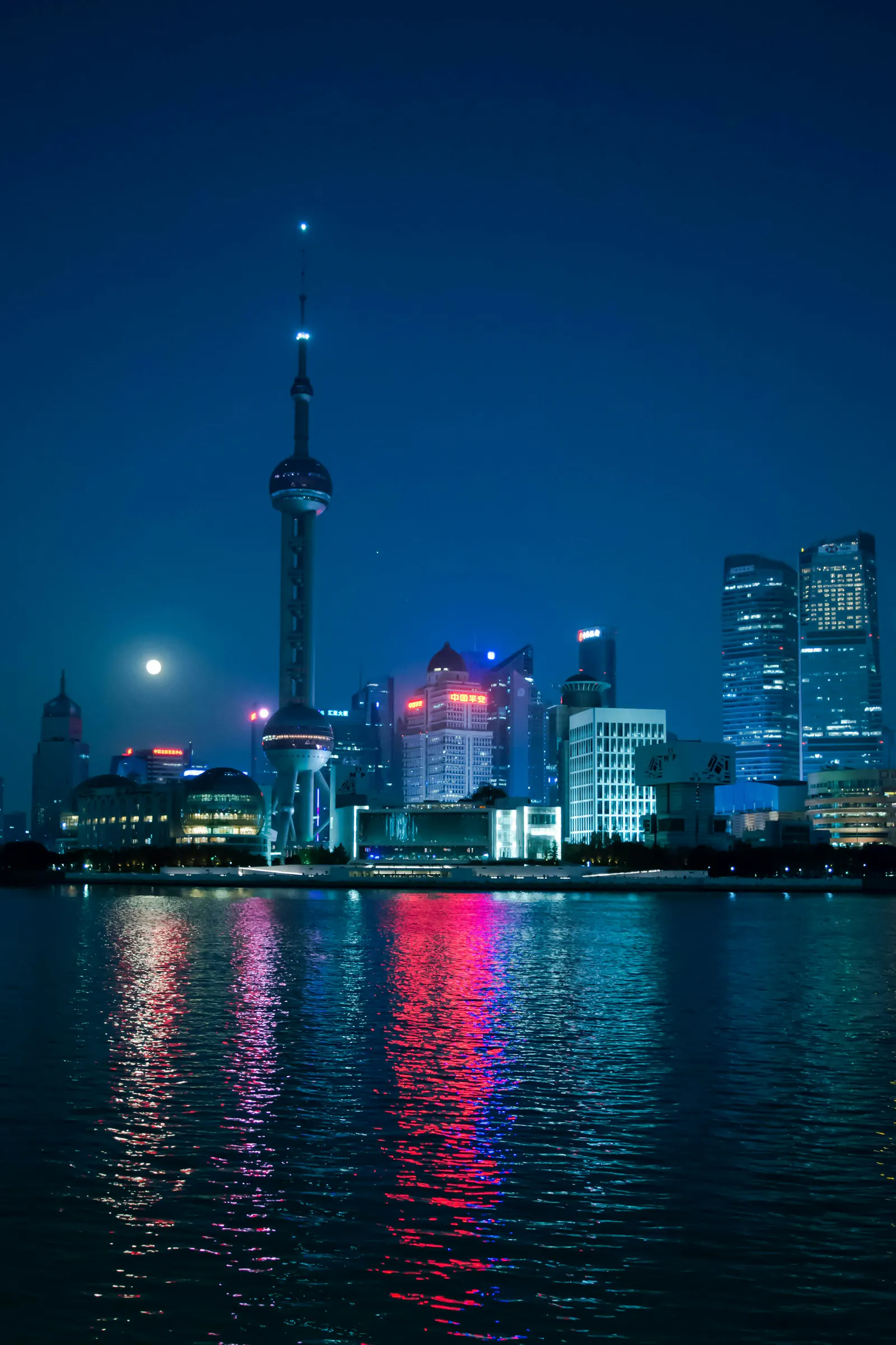 Shanghai's Pudong skyline reflected across the Huangpu River at night